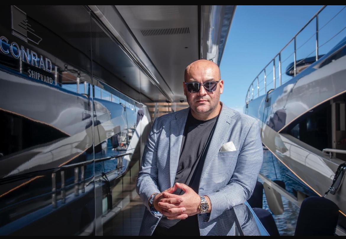 Ali standing alone aboard a Conrad yacht