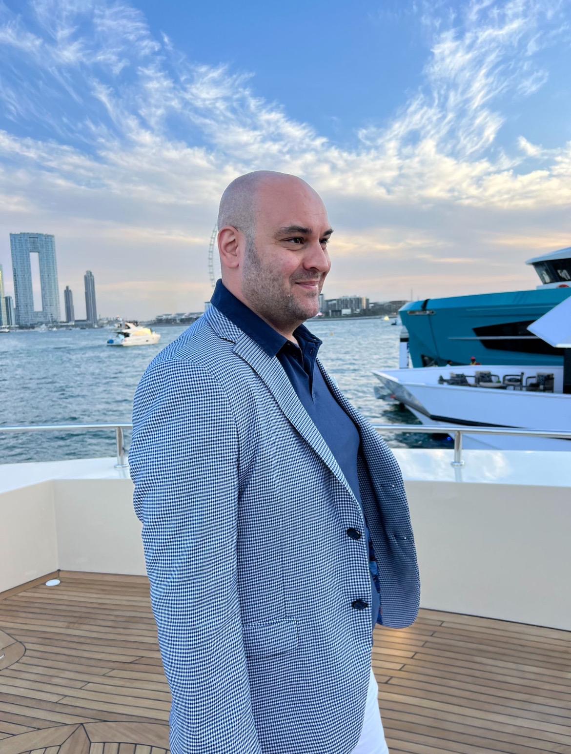 Ali standing alone on a yacht deck